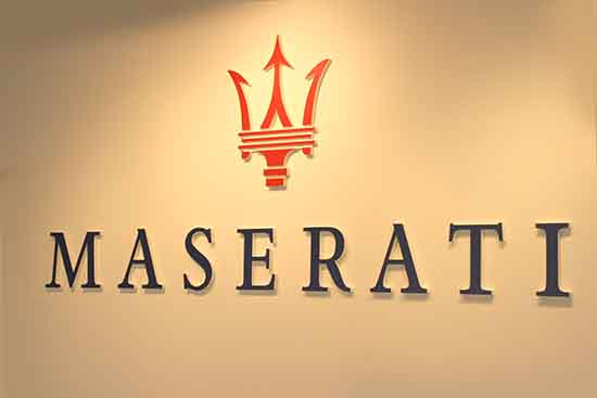 Maserati dealership identity, company showroom and sign.